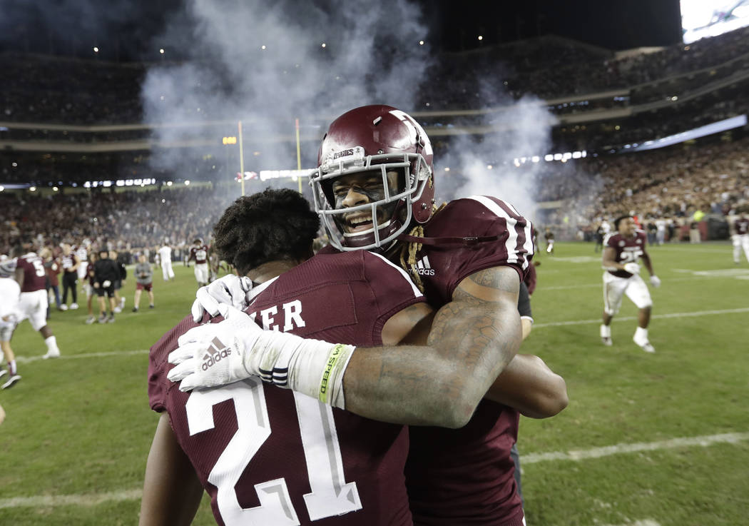 Texas A&M wide receiver Kendrick Rogers, right, celebrates with Charles Oliver (21) after an NCAA college football game against LSU Saturday, Nov. 24, 2018, in College Station, Texas. Texas A& ...