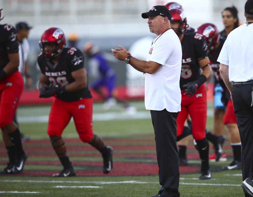 UNLV Rebels head coach Tony Sanchez watches as his players warm up before the start of a football game against Prairie View A&M Panthers at Sam Boyd Stadium in Las Vegas on Saturday, Sept. 15 ...
