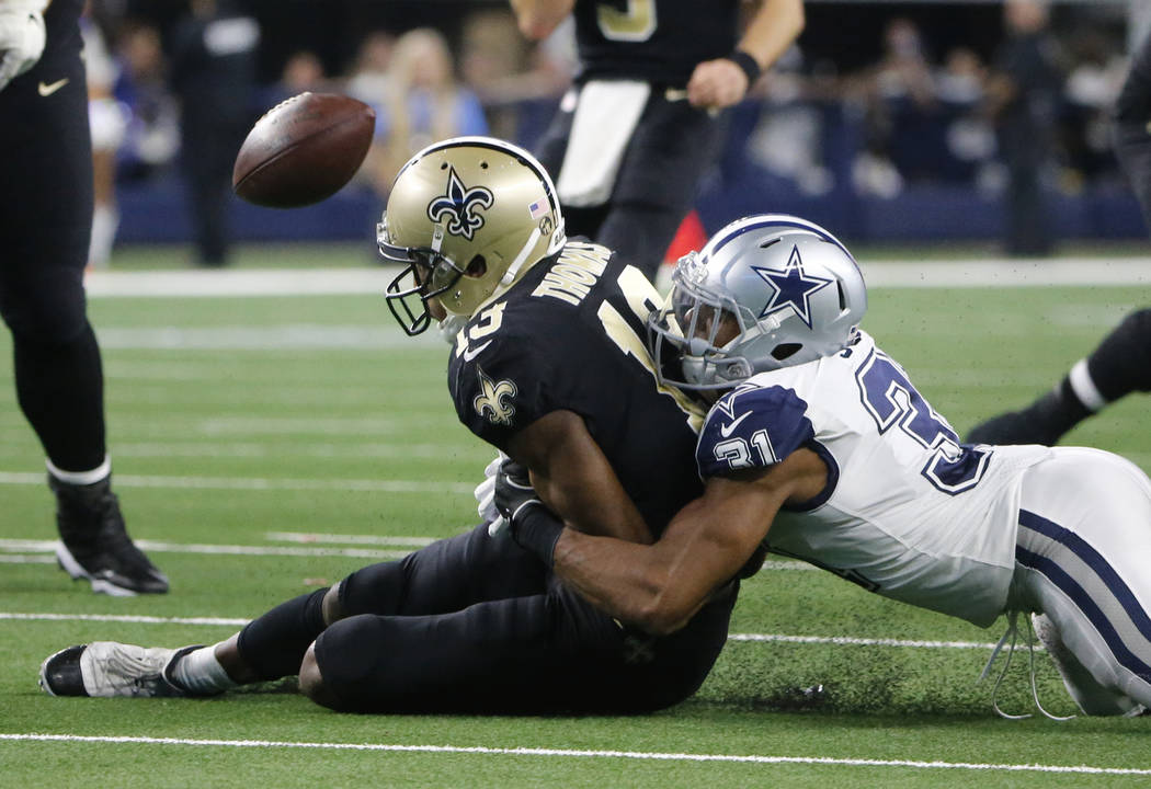 Dallas Cowboys cornerback Byron Jones (31) breaks up a pass intended for New Orleans Saints wide receiver Michael Thomas (13) during the second half of an NFL football game, in Arlington, Texas, T ...