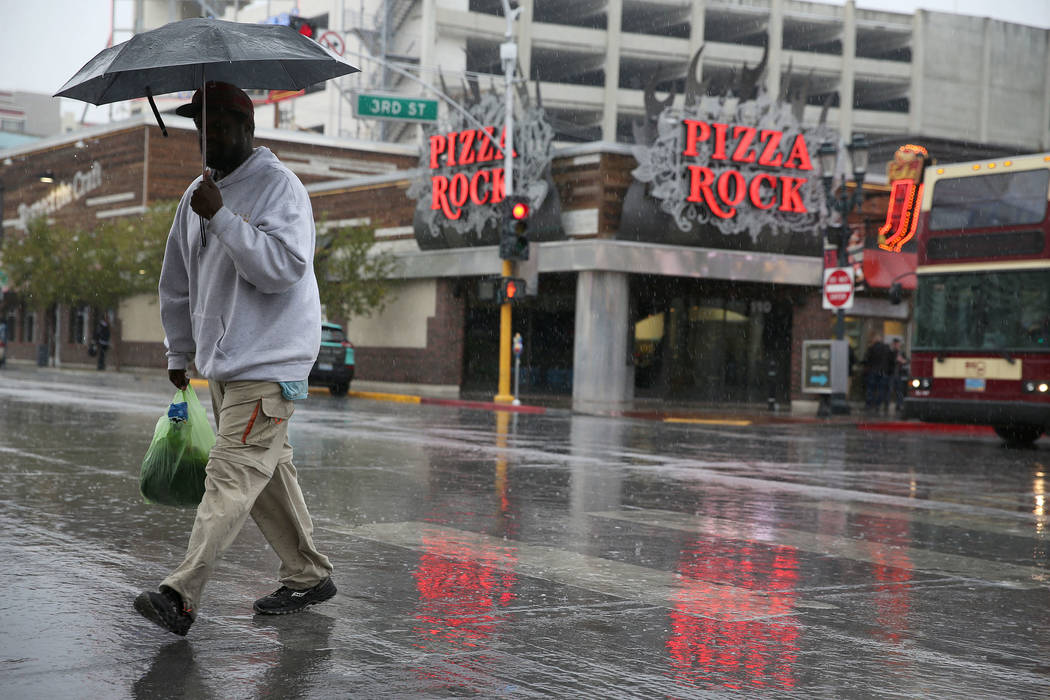 A person walks in downtown Las Vegas as rain falls, Thursday, Nov. 29, 2018. Erik Verduzco Las Vegas Review-Journal @Erik_Verduzco
