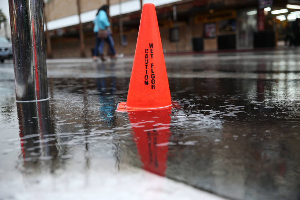 A cone sits on top of a water puddle in downtown Las Vegas as rain falls, Thursday, Nov. 29, 2018. Erik Verduzco Las Vegas Review-Journal @Erik_Verduzco