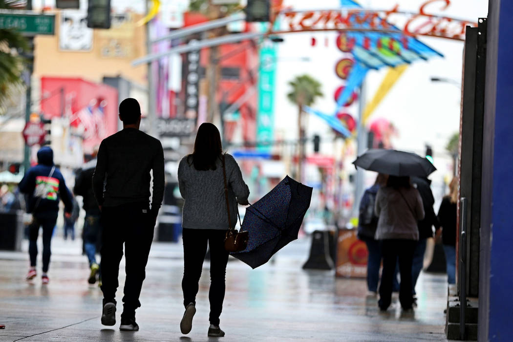 People walk in downtown Las Vegas as rain falls, Thursday, Nov. 29, 2018. Erik Verduzco Las Vegas Review-Journal @Erik_Verduzco