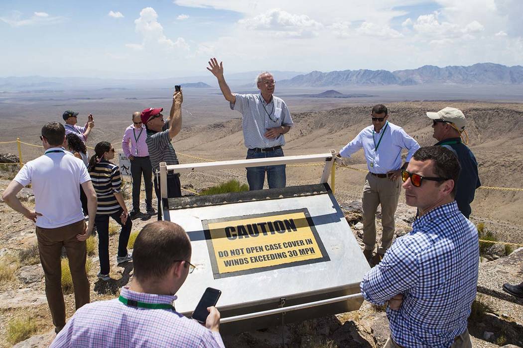 William Boyle of the Department of Energy's Office of Nuclear Energy, center, speaks at the crest of Yucca Mountain during a congressional tour near Mercury on Saturday, July 14, 2018. Chase Steve ...