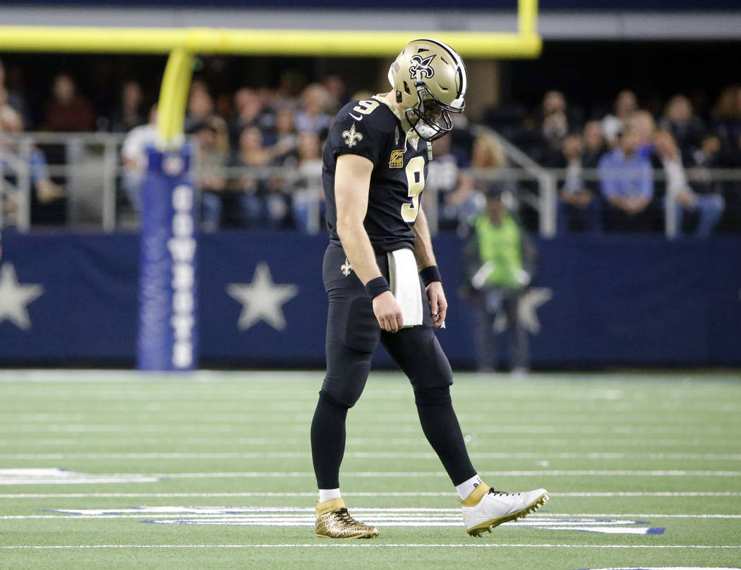 New Orleans Saints quarterback Drew Brees (9) walks off of the field in the first half of an NFL football game against the Dallas Cowboys, in Arlington, Texas, Thursday, Nov. 29, 2018. (AP Photo/M ...