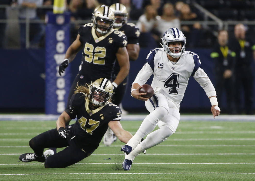 Dallas Cowboys quarterback Dak Prescott (4) scramble against the New Orleans Saints in the first half of an NFL football game, in Arlington, Texas, Thursday, Nov. 29, 2018. (AP Photo/Ron Jenkins)
