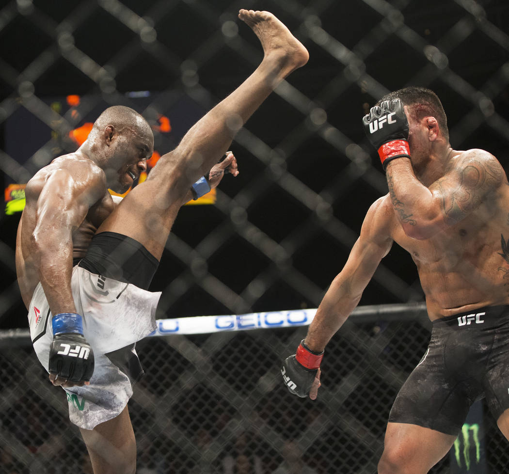Kamaru Usman, left, throws a kick against Rafael dos Anjos in the fourth round during "The Ultimate Fighter" Season 28 Finale on Friday, Nov. 30, 2018, at The Pearl, at Palms, in Las Vegas. Usman ...