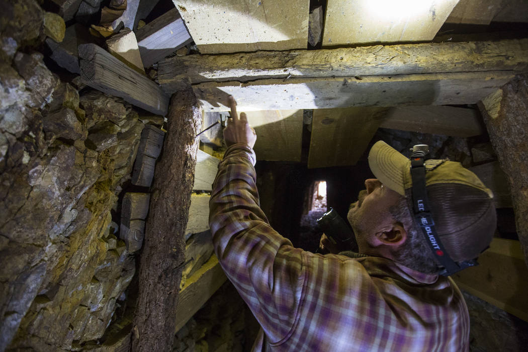 Caden Gould of Genoa looks at the old logs used insde of a mine while searching for vintage denim and other antiquities in south Douglas County on Thursday, Oct. 11, 2018. Mines in the area date a ...