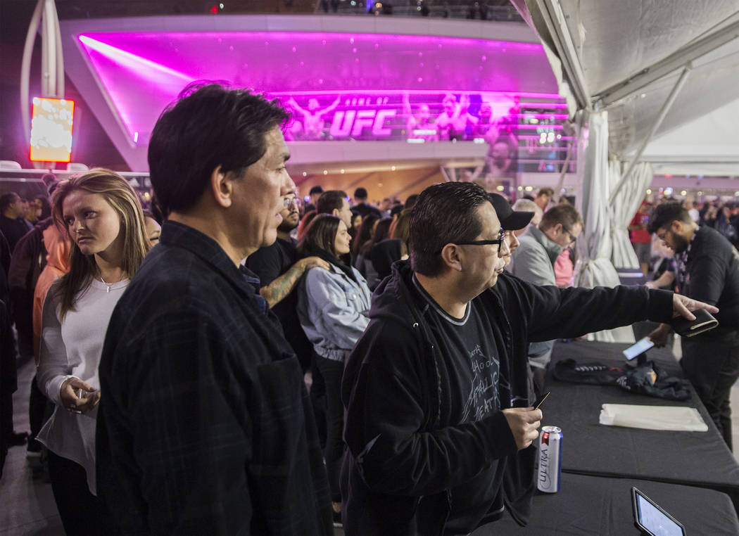 Reuben Parras, right, points out a shirt he wants to try on before the start of the Metallica show outside T-Mobile Arena on Monday, Nov. 26, 2018, in Las Vegas. Benjamin Hager Las Vegas Review-Jo ...
