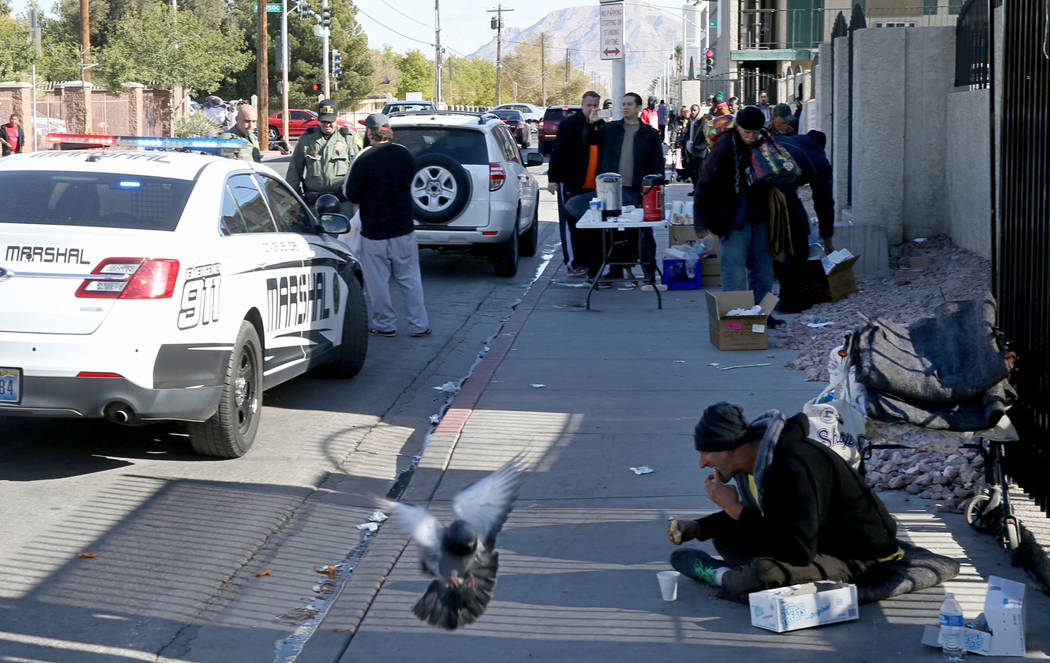 Las Vegas police and marshals cite a person for parking in a red zone on Foremaster Lane near Las Vegas Boulevard Wednesday, Nov. 28, 2018. The person had stopped to give out food. K.M. Cannon Las ...