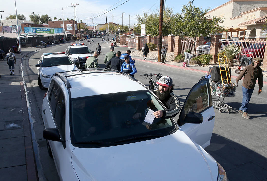 Joey Lankowski grabs a citation off his windshield where he was distributing food on Foremaster Lane near Las Vegas Boulevard Wednesday, Nov. 28, 2018. Lankowski was cited for parking in a red zon ...