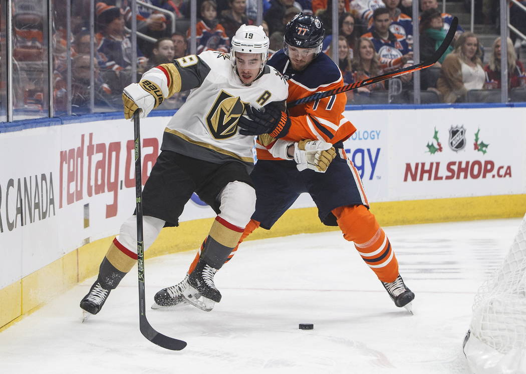 Vegas Golden Knights' Reilly Smith (19) and Edmonton Oilers' Oscar Klefbom (77) compete for the puck during the first period of an NHL hockey game Saturday, Dec. 1, 2018, in Edmonton, Alberta. (Ja ...