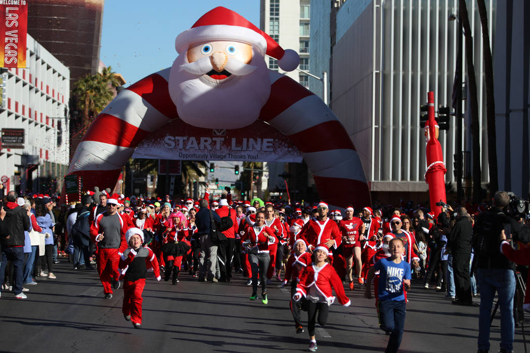 People start in the 14th annual Las Vegas Great Santa Run in downtown Las Vegas, Saturday, Dec. 1, 2018. The event benefits Opportunity Village. Erik Verduzco Las Vegas Review-Journal @Erik_Verduzco