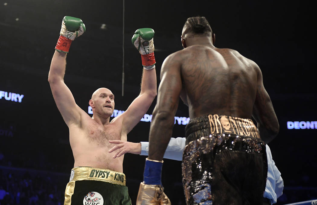 Tyson Fury, left, of England, taunts Deontay Wilder during the first round of a WBC heavyweight championship boxing match, Saturday, Dec. 1, 2018, in Los Angeles. (AP Photo/Mark J. Terrill)