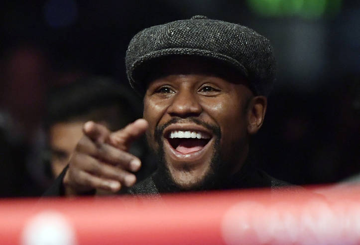 Boxer Floyd Mayweather points to someone in the crowd as he watches a boxing match between Deontay Wilder and Tyson Fury, of England, for the WBC heavyweight championship, Saturday, Dec. 1, 2018, ...