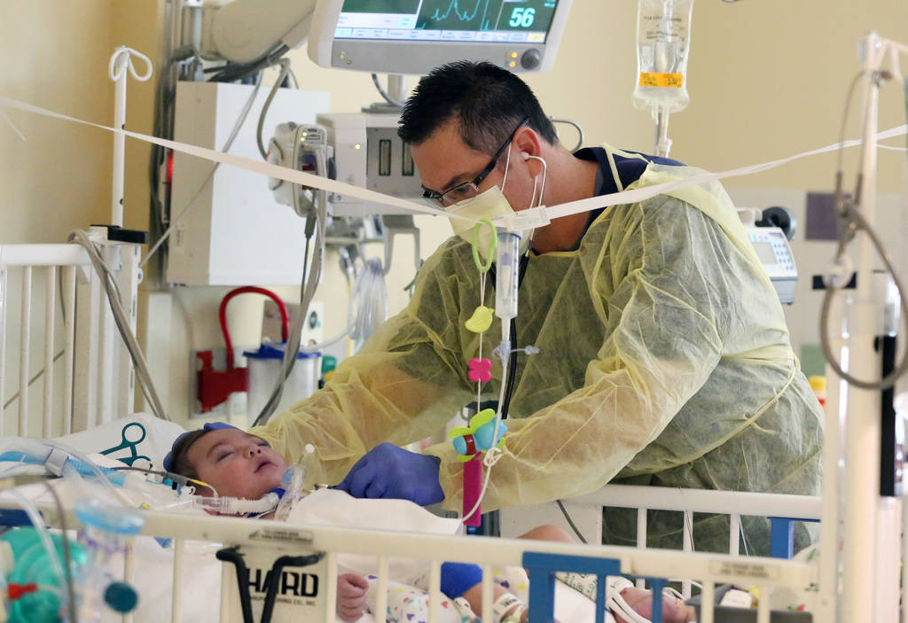 Dr. Oscar Ingaramo, Sunrise Children's Hospital PICU Medical director, checks Roman Ludice at Sunrise Children's Hospital on Monday, Dec. 3, 2018, in Las Vegas. Ludice was born Dec. 13, 2017 and h ...