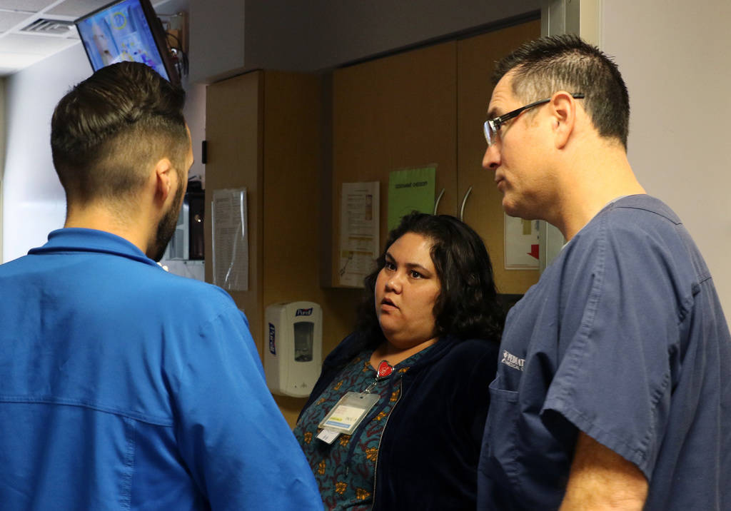 Dr. Oscar Ingaramo, right, Sunrise Children's Hospital PICU Medical director, and Arthur Ludice, nurse manager, discuss with Vanessa Macias, center, about hers son's condition on Monday, Dec. 3, 2 ...