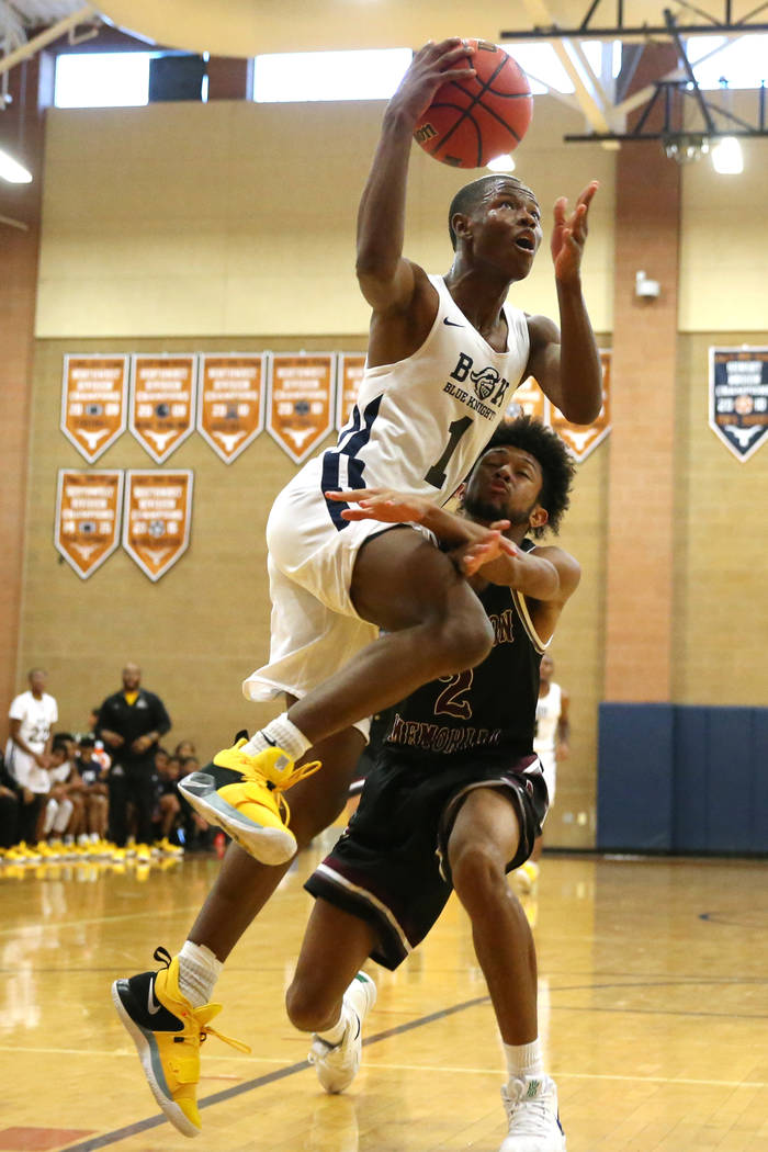 Democracy Prep's Najeeb Muhammad (1) goes up for a shot against Cimarron-Memorial's Isaiah Armstrong (2) in their basketball game at Legacy High School in North Las Vegas, Friday, Nov. 30, 2018. E ...