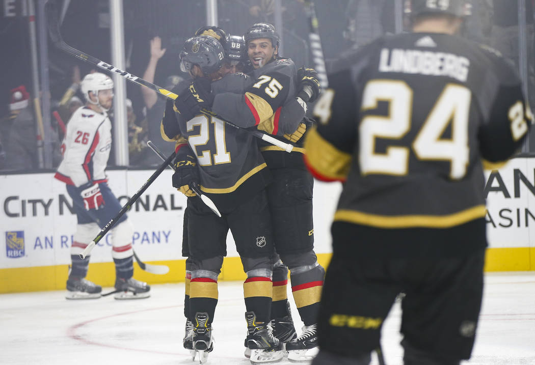 Golden Knights right wing Ryan Reaves (75) celebrates his goal with Cody Eakin, left, and Nate Schmidt during the first period of an NHL hockey game against the Washington Capitals at T-Mobile Are ...