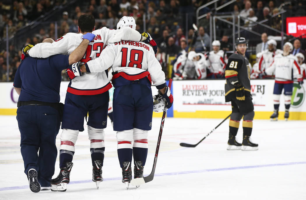 Washington Capitals right wing Tom Wilson (43) is helped off the ice after taking a hit from Golden Knights right wing Ryan Reaves, not pictured, during the second period of an NHL hockey game at ...