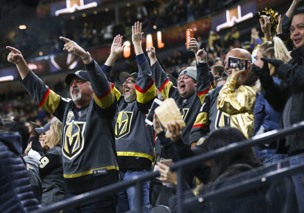 Golden Knights fans celebrate a goal by Golden Knights center Cody Eakin, not pictured, during the third period of an NHL hockey game at T-Mobile Arena in Las Vegas on Tuesday, Dec. 4, 2018. Chase ...
