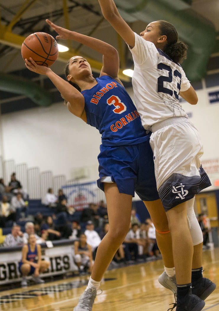 Bishop Gorman's Georgia Ohiaeri (3) shoots against Spring Valley's Alexus Quaadman (23) during the second half of a varsity basketball game at Spring Valley High School in Las Vegas on Tuesday, De ...