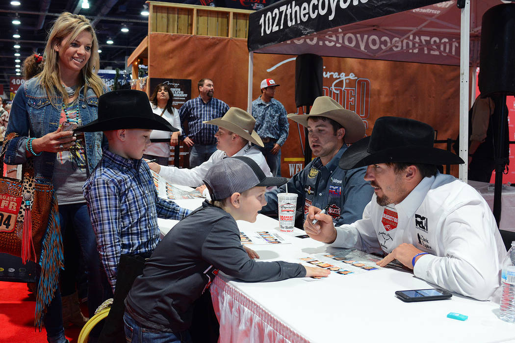 Steer Wrestler Tyler Pearson engages with a young fan at an autograph session at Cowboy Christmas during the 2017 Wrangler National Finals Rodeo. Photo by Steve Spatafore/Special to the Review-Journal