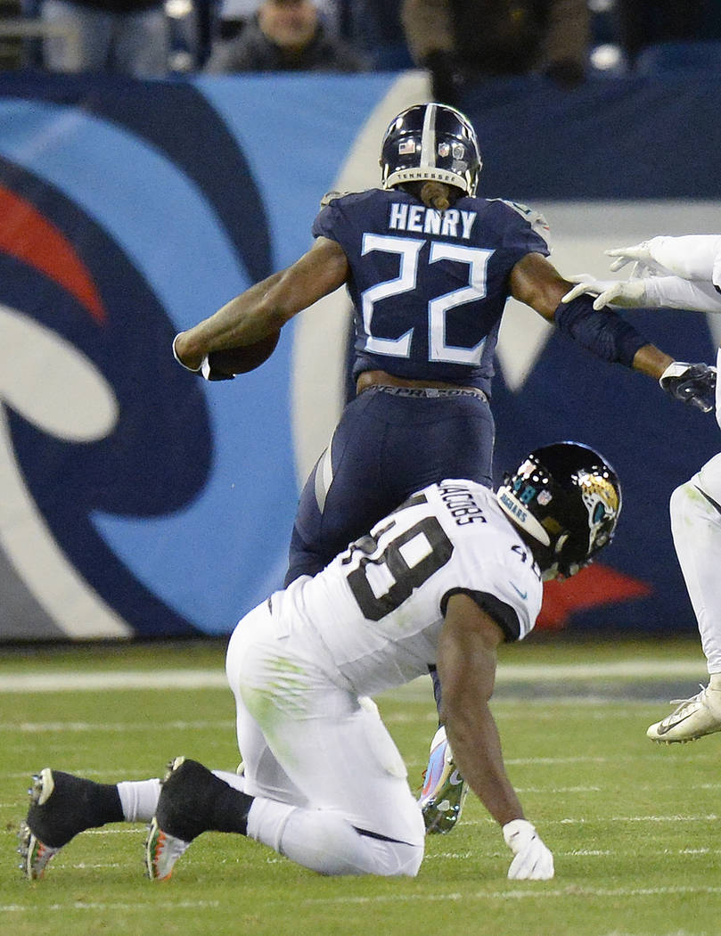 Tennessee Titans running back Derrick Henry (22) runs past Jacksonville Jaguars outside linebacker Leon Jacobs (48) for a touchdown during the first half of an NFL football game, Thursday, Dec. 6, ...