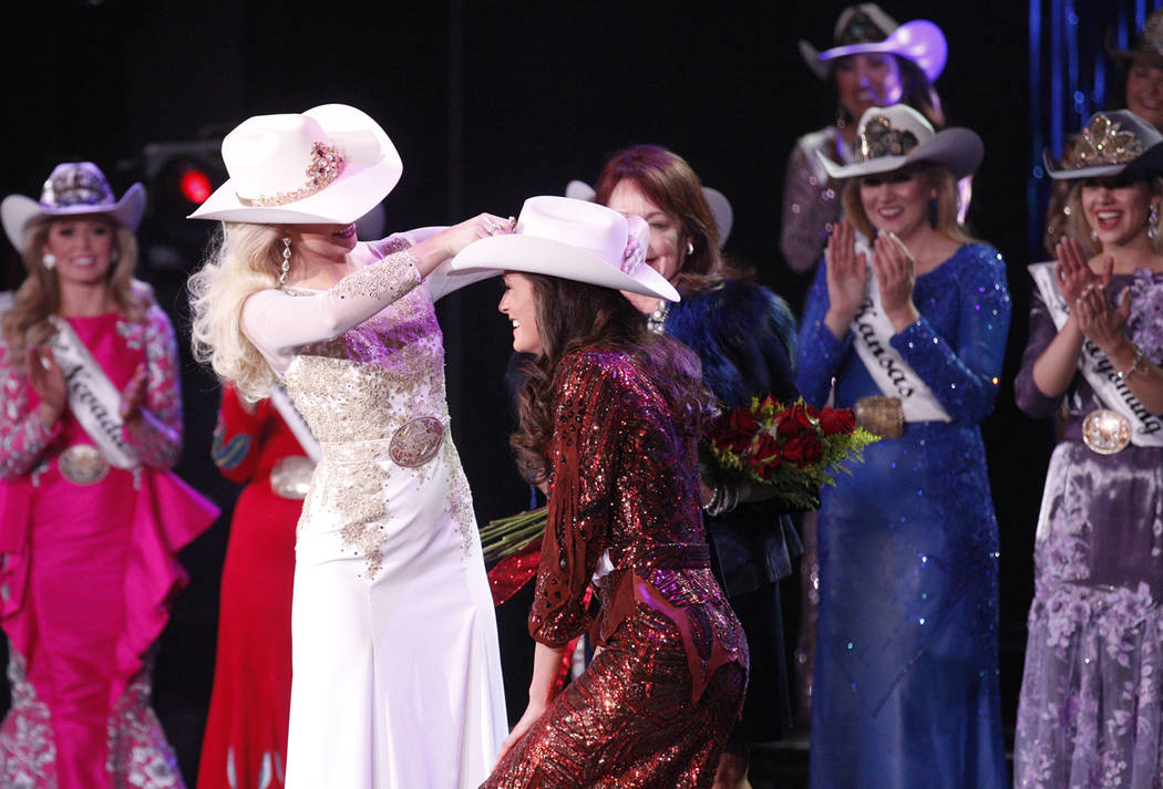 Miss Rodeo America 2018 Kerri Sheffield places a crown on the 2019 winner Miss Rodeo Mississipp ...
