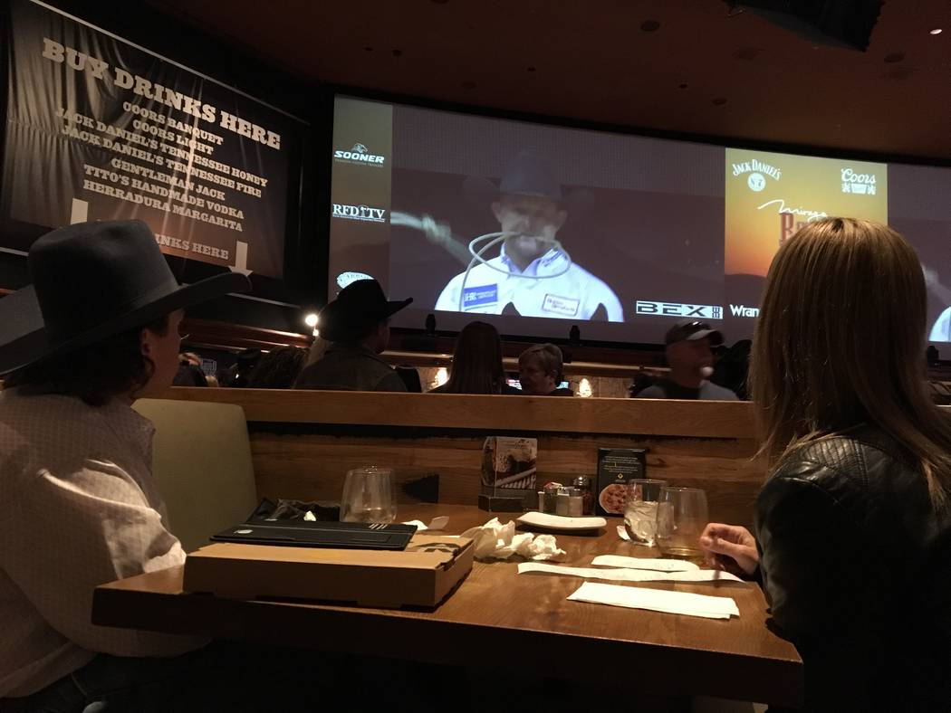 Brandon Noel and Donna Collins of Oakdale, Calif., enjoy Friday night's Wrangler NFR viewing party from a table at California Pizza Kitchen, which is adjacent to the sports book at The Mirage. Pat ...