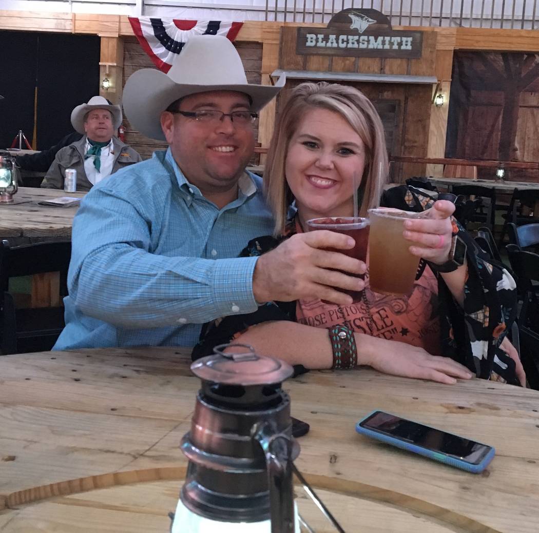 Tater and Courtney Wilbanks of Beebe, Ark., raise a toast to the rodeo while gearing up for Friday night's Wrangler NFR viewing party at the Downtown Las Vegas Events Center. The venue is one of m ...