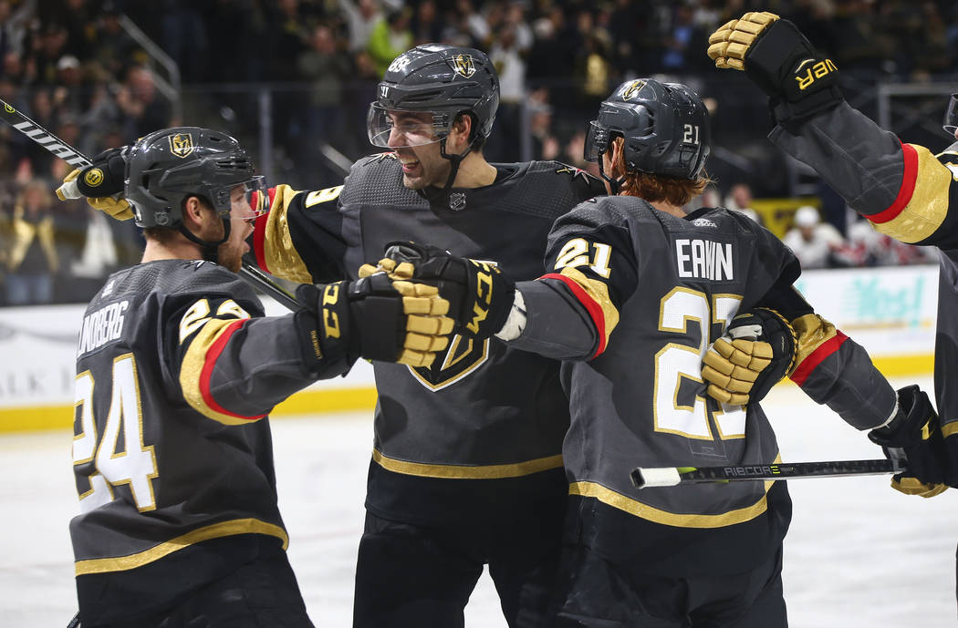 Golden Knights center Cody Eakin (21) celebrates his goal with teammates Oscar Lindberg (24) and Alex Tuch during the third period of an NHL hockey game against the Washington Capitals at T-Mobile ...