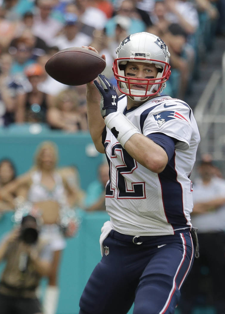 New England Patriots quarterback Tom Brady (12) look to pass, during the first half of an NFL football game against the Miami Dolphins, Sunday, Dec. 9, 2018, in Miami Gardens, Fla. (AP Photo/Lynne ...