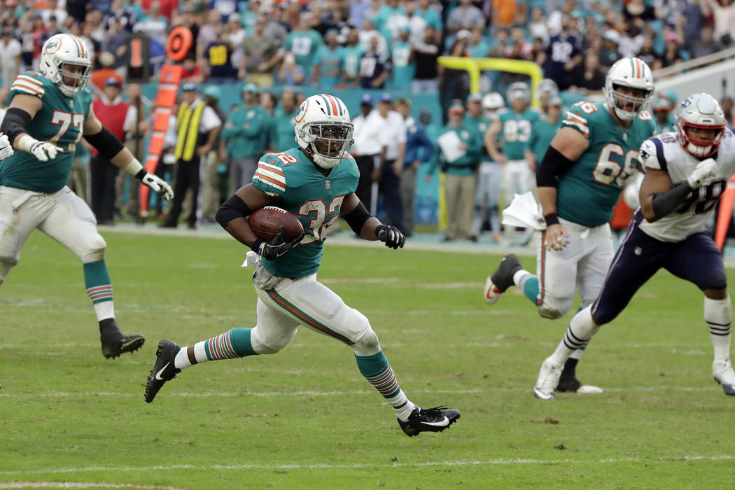Miami Dolphins running back Kenyan Drake (32) runs for a touchdown, during the second half of an NFL football game against the New England Patriots, Sunday, Dec. 9, 2018, in Miami Gardens, Fla. (A ...