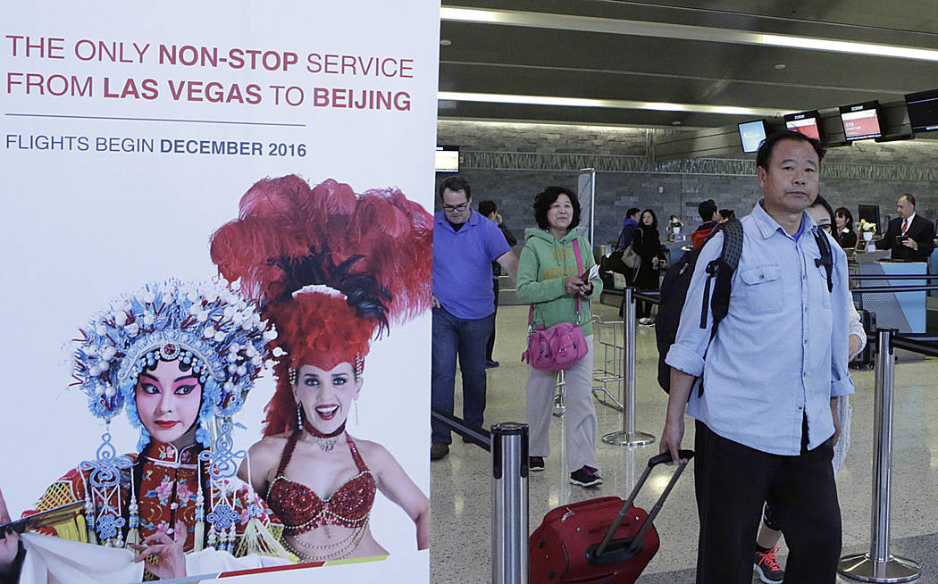 Passengers head to board a Hainan Airlines flight after checking-in at the ticket counter on Monday, Feb. 27, 2017 at McCarran International Airport in Las Vegas. (Bizuayehu Tesfaye/Las Vegas Revi ...