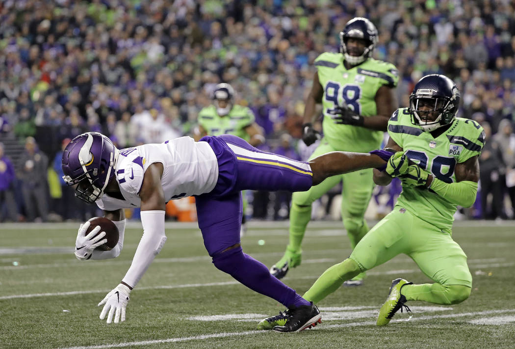 Seattle Seahawks' Justin Coleman, right, brings down Minnesota Vikings' Laquon Treadwell after a pass reception by Treadwell in the second half of an NFL football game, Monday, Dec. 10, 2018, in S ...