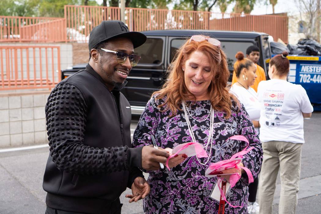 Strip headliner Eddie Griffin is shown looking over holiday cards with The Shade Tree Executive Director Stacey Lockhart on Monday, Dec. 10, 2018. (Joshua Chévere Cohen/Prickly Pear Marketing)