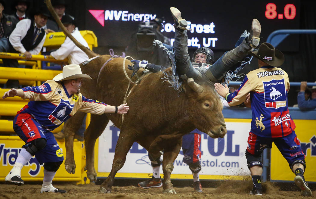 Joe Frost of Randlett, Utah (103) struggles to stay on "Mortimer" while competing in bull riding during the sixth go-round of the National Finals Rodeo at the Thomas & Mack Center in ...
