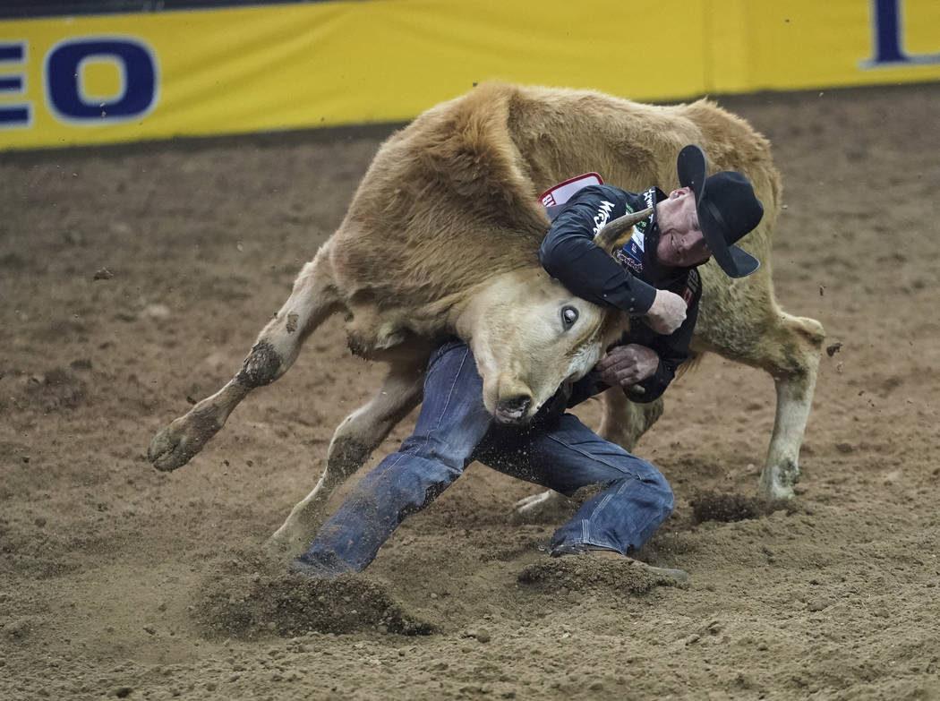 Curtis Cassidy of Alberta, Canada competes in the steer wrestling event during the sixth go-round of the National Finals Rodeo at the Thomas & Mack Center in Las Vegas on Tuesday, Dec. 11, 201 ...