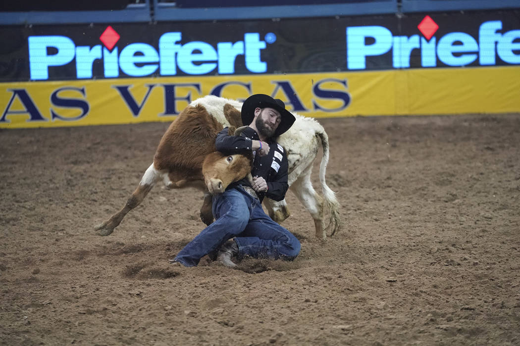 Bridger Chambers of Stevensville, Mont. competes in the steer wrestling event during the sixth go-round of the National Finals Rodeo at the Thomas & Mack Center in Las Vegas on Tuesday, Dec. 1 ...