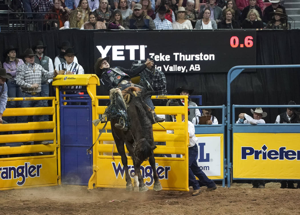 Zeke Thurston of Alberta, Canada competes in the saddle bronc riding event during the sixth go-round of the National Finals Rodeo at the Thomas & Mack Center in Las Vegas on Tuesday, Dec. 11, ...