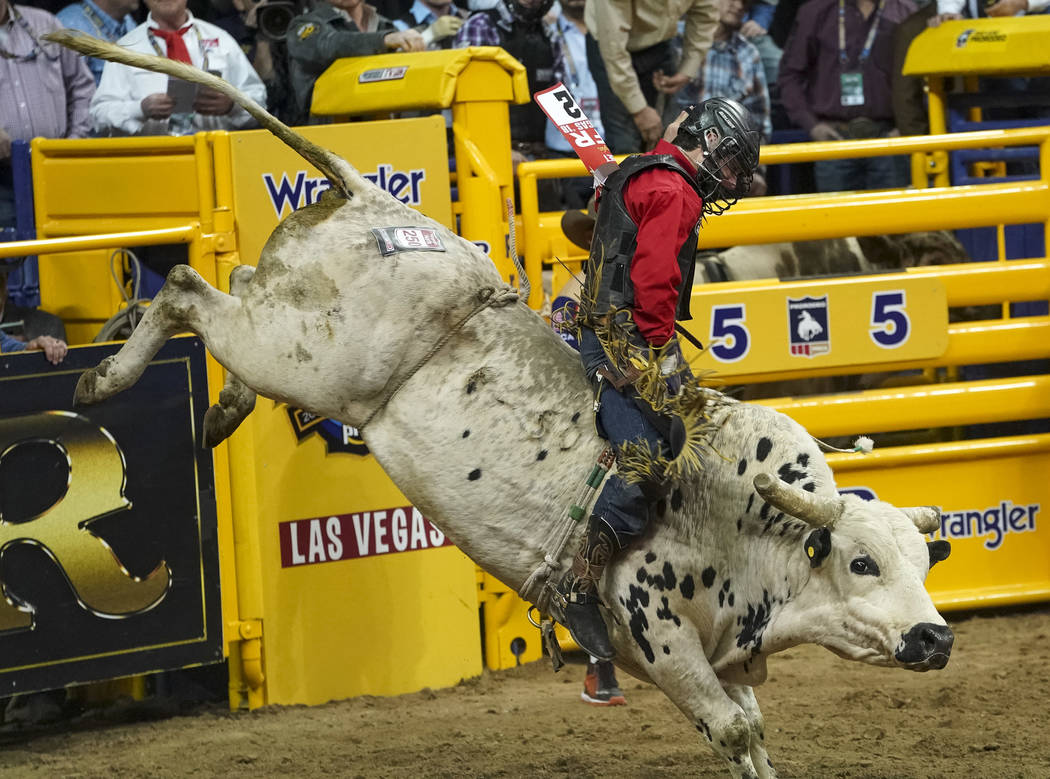 Dustin Boquet of Bourg, La. competes in the bull riding event during the sixth go-round of the National Finals Rodeo at the Thomas & Mack Center in Las Vegas on Tuesday, Dec. 11, 2018. Richard ...