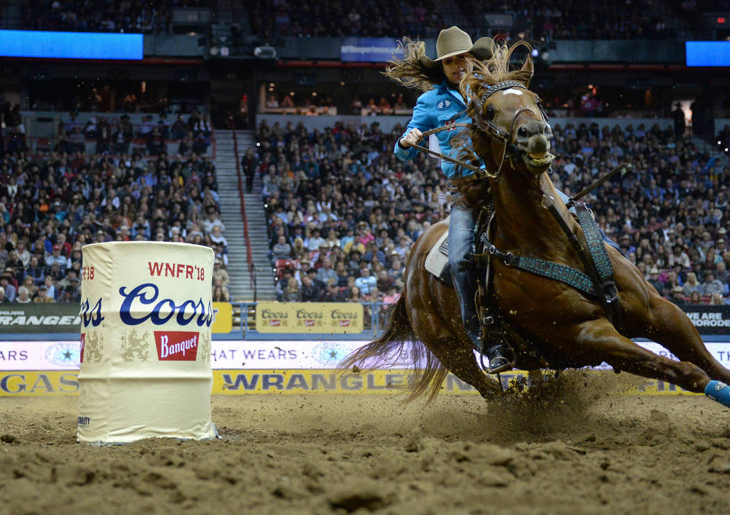 Brittany Pozzi of Tonozzi of Victoria, Texas (11) competes in Barrel Racing during the sixth go-round of the National Finals Rodeo at the Thomas & Mack Center in Las Vegas, Tuesday, Dec. 11, 2 ...