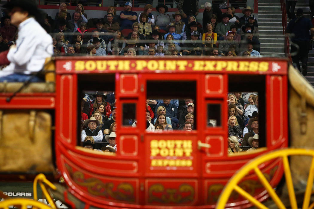 A South Point Express carriage makes its way through the arena as fans watch during the sixth go-round of the National Finals Rodeo at the Thomas & Mack Center in Las Vegas, Tuesday, Dec. 11, ...