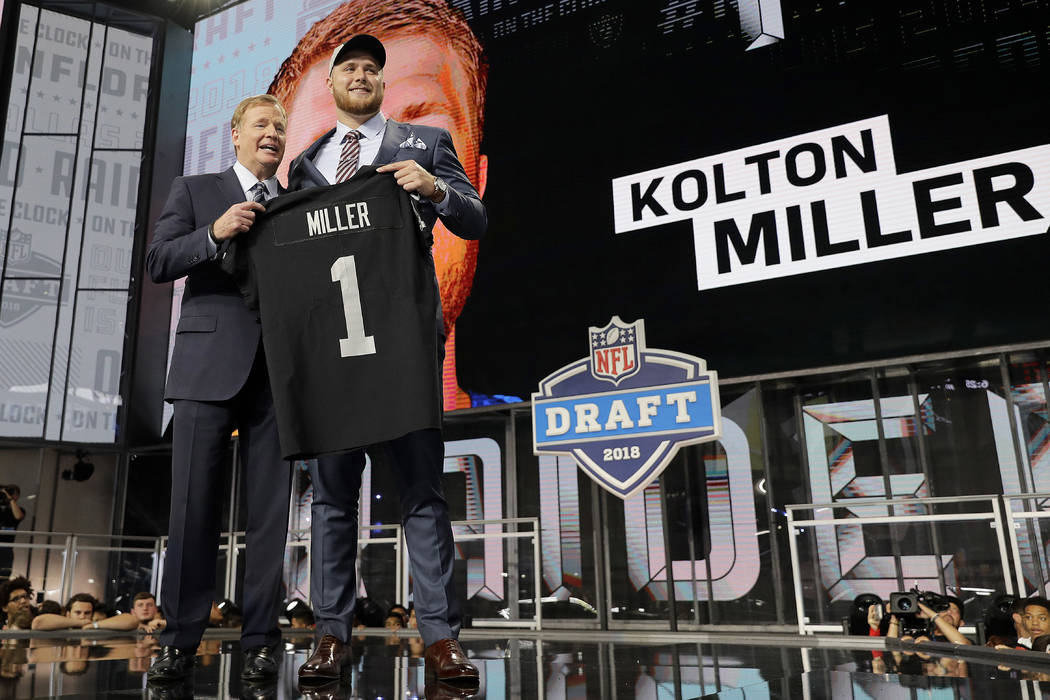 Commissioner Roger Goodell, left, presents UCLA's Kolton Miller with his Oakland Raiders jersey during the first round of the NFL football draft, Thursday, April 26, 2018, in Arlington, Texas. (AP ...