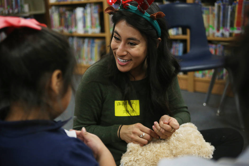 Karen Avila helps Lisbeth Ramon San Pedro, 7, sew up her stuffed bear at the Build-A-Bear-Workshop at Doris Reed Elementary School in Las Vegas, Thursday, Dec. 13, 2018. Rachel Aston Las Vegas Rev ...