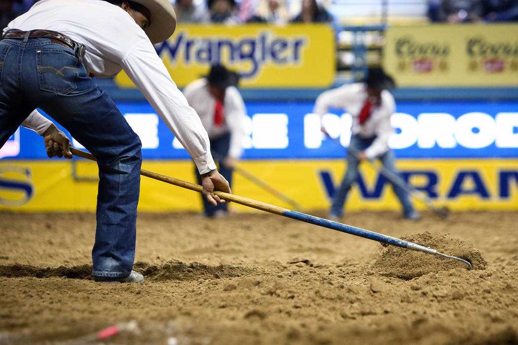 Maintenance workers rake up the dirt in the arena between events during sixth go-round of the National Finals Rodeo at Thomas & Mack Center in Las Vegas, Tuesday, Dec. 11, 2018. Caroline Brehm ...