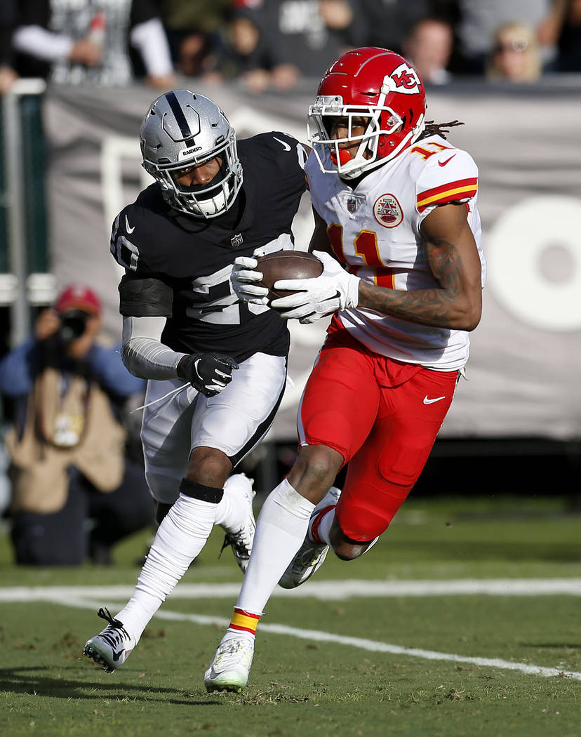 Kansas City Chiefs wide receiver Demarcus Robinson (11) runs in front of Oakland Raiders cornerback Daryl Worley (20) during the first half of an NFL football game in Oakland, Calif., Sunday, Dec. ...