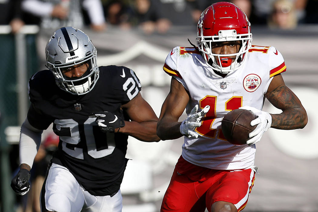 Kansas City Chiefs wide receiver Demarcus Robinson (11) runs in front of Oakland Raiders cornerback Daryl Worley (20) during the first half of an NFL football game in Oakland, Calif., Sunday, Dec. ...