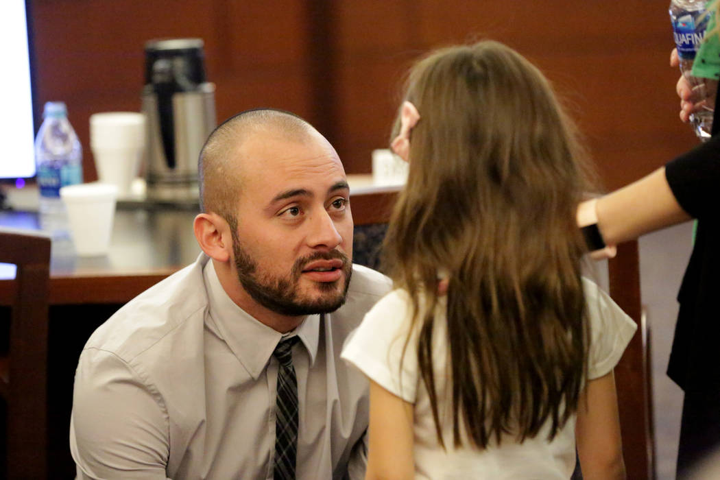 Jose Navarrete, one of two former Nevada Department of Corrections officers accused of using unnecessary force on an inmate, talks to his 5-year-old daughter Savannah after closing statements on F ...