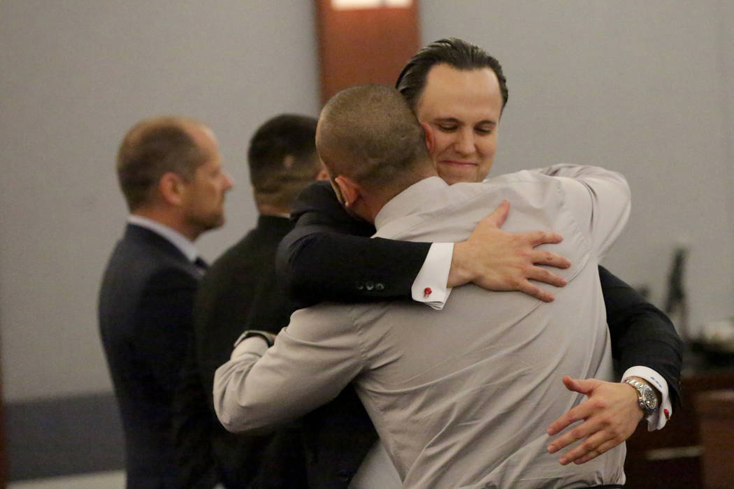 Defense attorney Kyle Cottner embraces his client Jose Navarrete, one of two former Nevada Department of Corrections officers accused of using unnecessary force on an inmate, after a jury returns ...